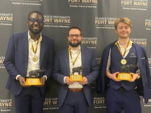 Charles Dankyi with his team members holding their first-place trophies